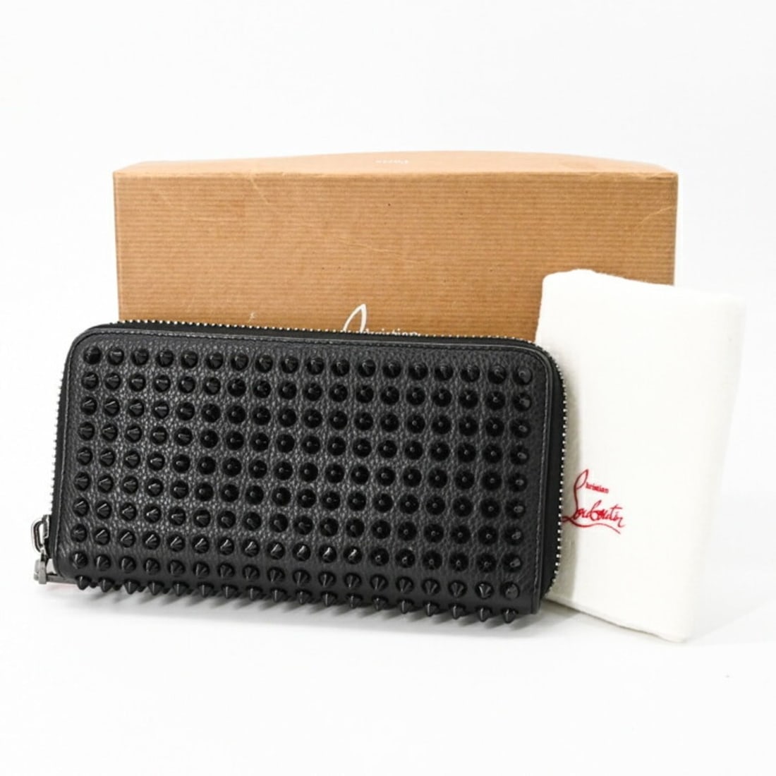 Christian Louboutin Panettone Studded Round Wallet in Black Leather (1165044): --- Catalog ---Category: SizeSize (HxWxD): 10cm x 19.5cm x 2.5cm / 3.93'' x 7.67'' x 0.98''Category: DesignType: Long wallet (bi-fold)Color: BlackGender: WomenCategory: GeneralBrand: Christian Loubout
