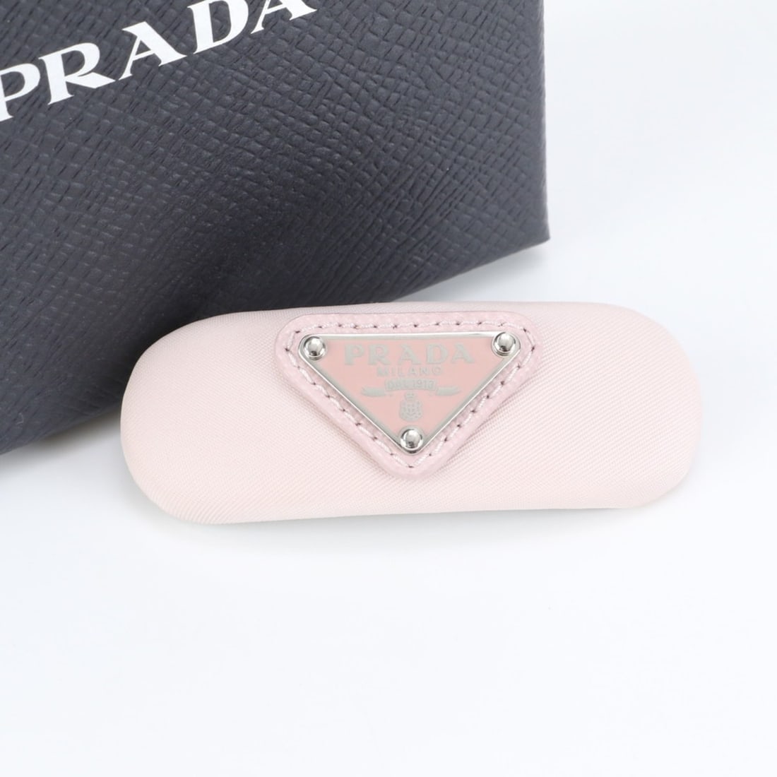 Prada Tessuto Nylon Triangle Logo Barrette 1IF129 Pink Hair Accessory for Women: --- Catalog ---Category: SizeSize (LxW): 2cm x 7cm / 0.78'' x 2.75''Category: DesignType: BarretteColor: PinkGender: WomenMaterial: NylonCategory: GeneralMPN: 1IF129Brand: PradaCountry of Origin: Ital