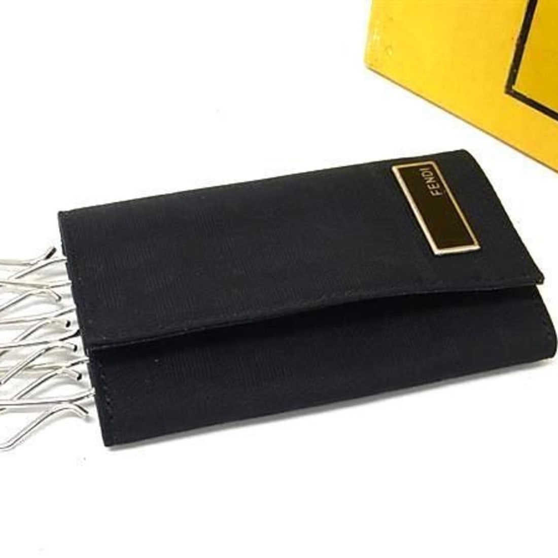 FENDI Zucca Key Case 2270 10163 099 Black Nylon and Leather 6-Ring Ring for Men Women: --- Catalog ---Category: DesignType: KeycaseColor: BlackGender: Men,Women,UnisexMaterial: Nylon , Leather Number of Key Hooks: 6Category: GeneralLine: ZuccaBrand: FendiCountry of Origin: ItalyCategory