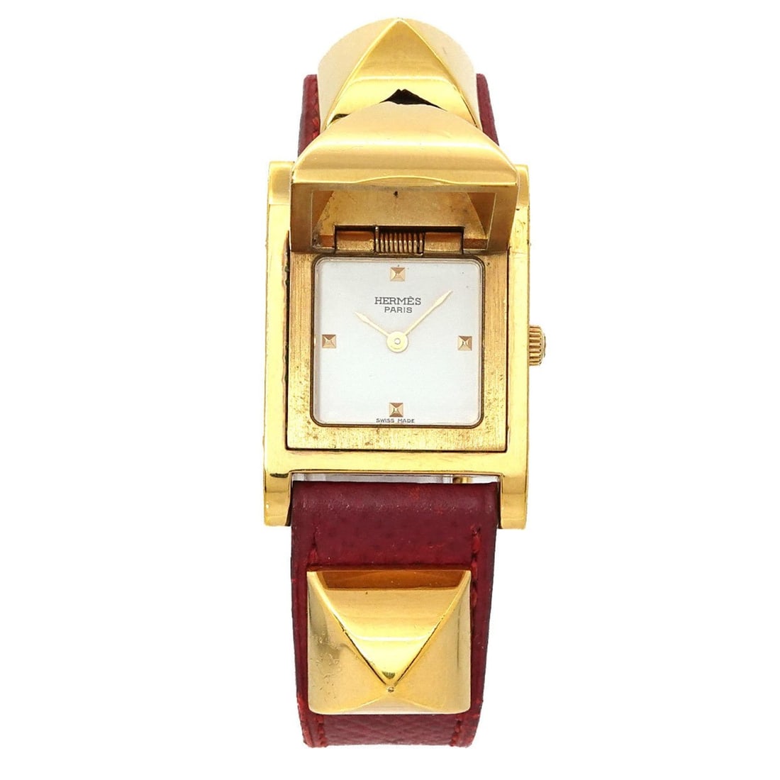 Hermès Medor Women's Pyramid Gold Stud Watch in White and Red Leather with Quartz Movement: --- Catalog ---Category: SizeWrist Size: 13.5cm - 16.5cm / 5.31'' - 6.49''Case Diameter: 23mm / 0.91''Category: DesignType: WristwatchGender: WomenColor (Dial): WhiteMaterial (Band): Gold plated, Leat