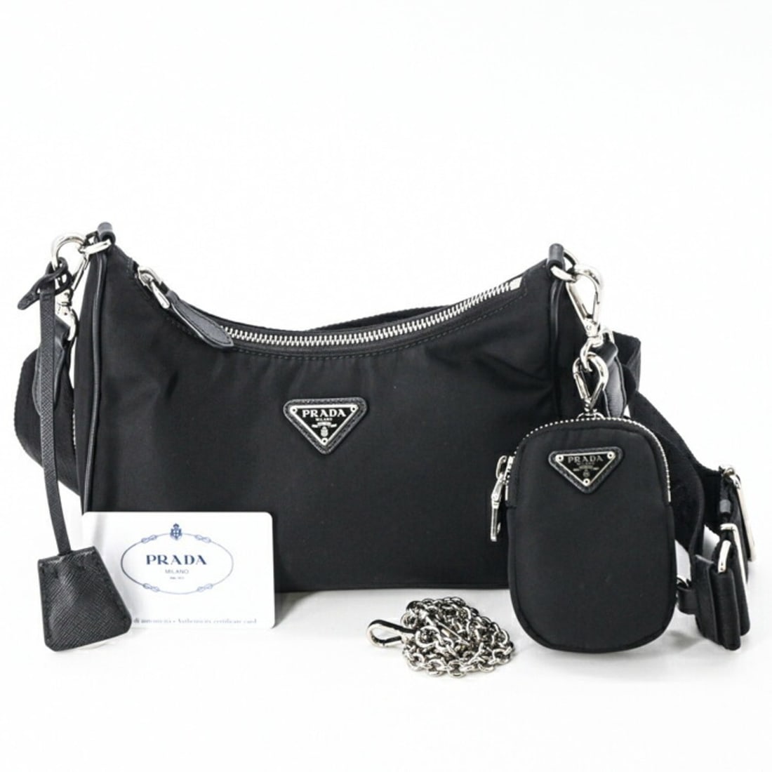 PRADA Re-Edition 2005 Re-Nylon Shoulder Handbag in Tessuto Black (1BH204): --- Catalog ---Category: SizeSize (HxWxD): 16cm x 22cm x 6cm / 6.29'' x 8.66'' x 2.36''Category: DesignType: Handbag, Shoulder bagColor: BlackGender: WomenMaterial: Nylon Category: GeneralBrand: Prada