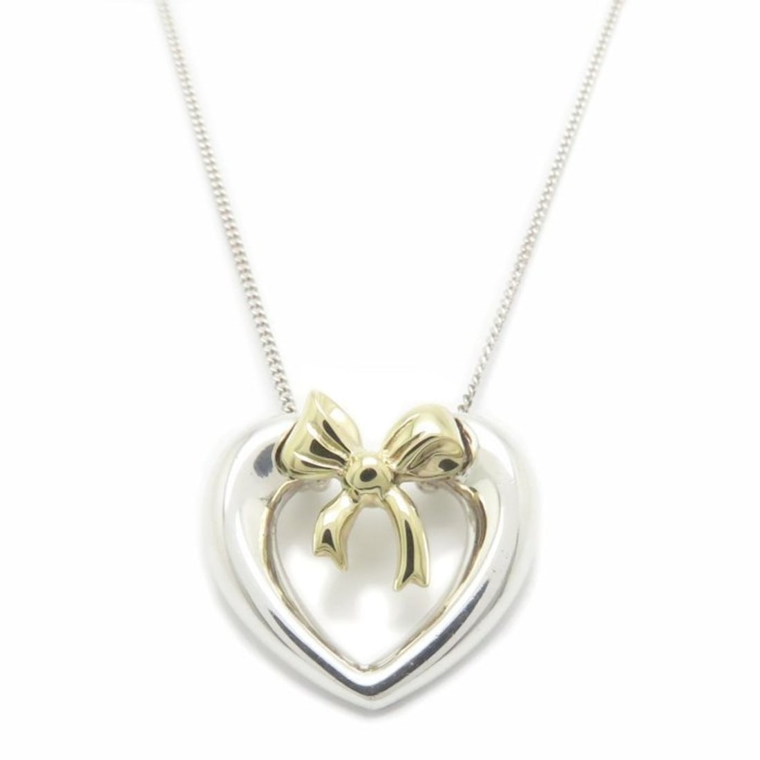 TIFFANY & Co. Tiffany Heart Ribbon Necklace in SV925 and 18KYG, Women's, 295008: --- Catalog ---Category: SizeWeight: 4.3g / 0.15oz.Pendant Size: 17.1mm x 18.2mm / 0.67'' x 0.71''Neck Circumference: 44.5 cm / 17.51''Category: DesignGender: WomenMaterial: Silver 925, Yellow gold