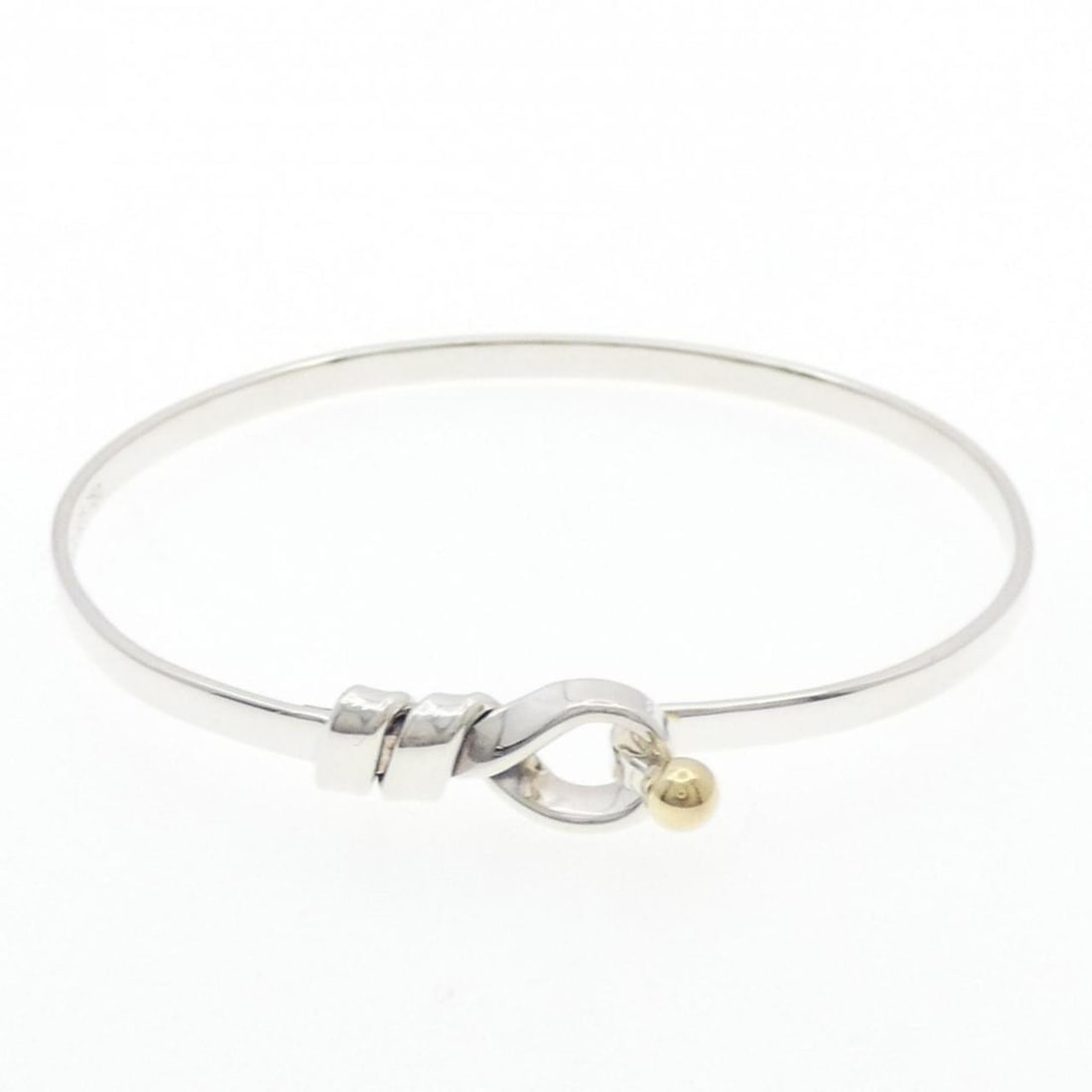Tiffany Hook & Eye Bangle: --- Catalog ---Category: SizeLength: 17cm / 6.69''Category: DesignType: BangleGender: WomenMaterial: Silver 925, Yellow gold (18K)Category: GeneralBrand: Tiffany--- Item List ---Section: