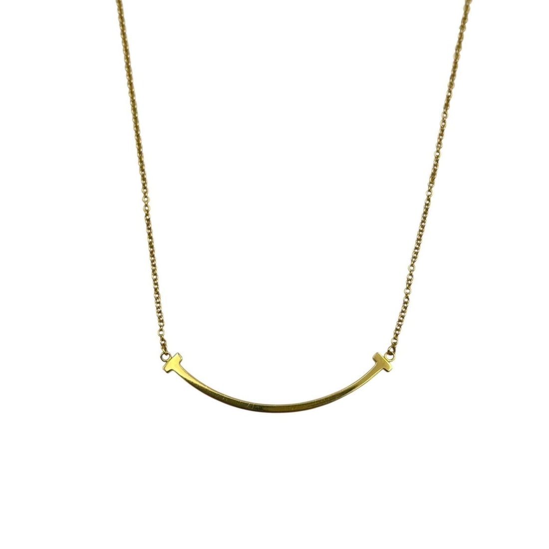 Tiffany & Co. T Smile Necklace in 18K Yellow Gold for Women: --- Catalog ---Category: SizePendant Size: 8mm x 37mm / 0.31'' x 1.45''Neck Circumference: 41 cm / 16.14''Category: DesignColor: GoldGender: WomenMaterial: Yellow gold (18K)Necklace Type: