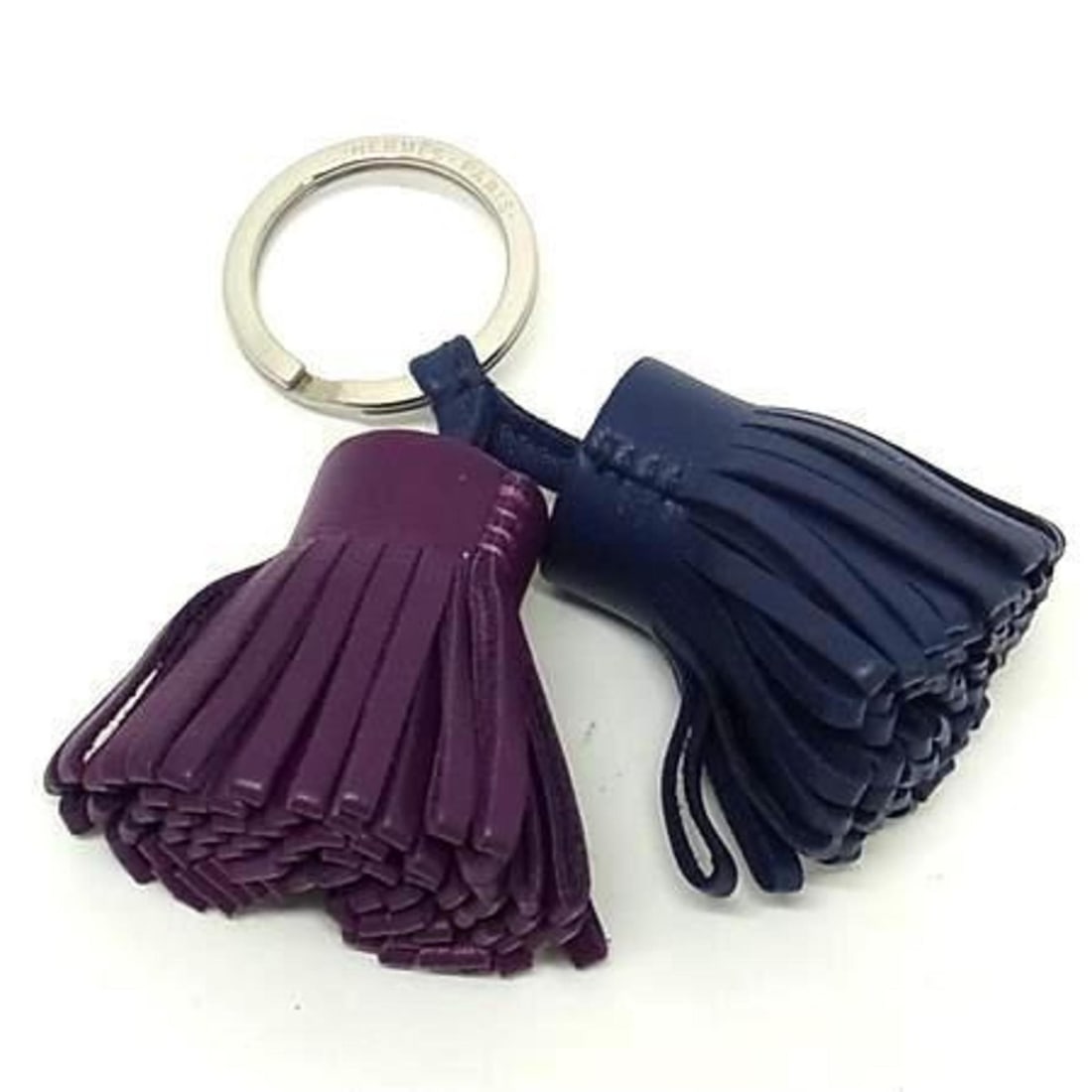 HERMES Carmen Unodos Keychain Charm in Blue and Purple Leather for Men Women: --- Catalog ---Category: DesignType: KeyringColor: Blue, PurpleGender: Men,Women,UnisexMaterial: LeatherCategory: GeneralLine: CarmenBrand: HermesCountry of Origin: France--- Item List ---Section: Con