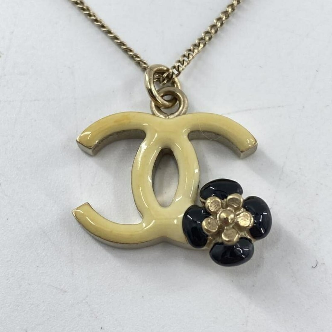 CHANEL Coco Mark Camellia Necklace Ivory Black Gold Chanel: --- Catalog ---Category: SizePendant Size: 20mm x 20mm / 0.78'' x 0.78''Neck Circumference: 43.5 cm / 17.12''Category: DesignColor: Black, Gold, IvoryGender: WomenNecklace Type: NecklaceCategory: Gene