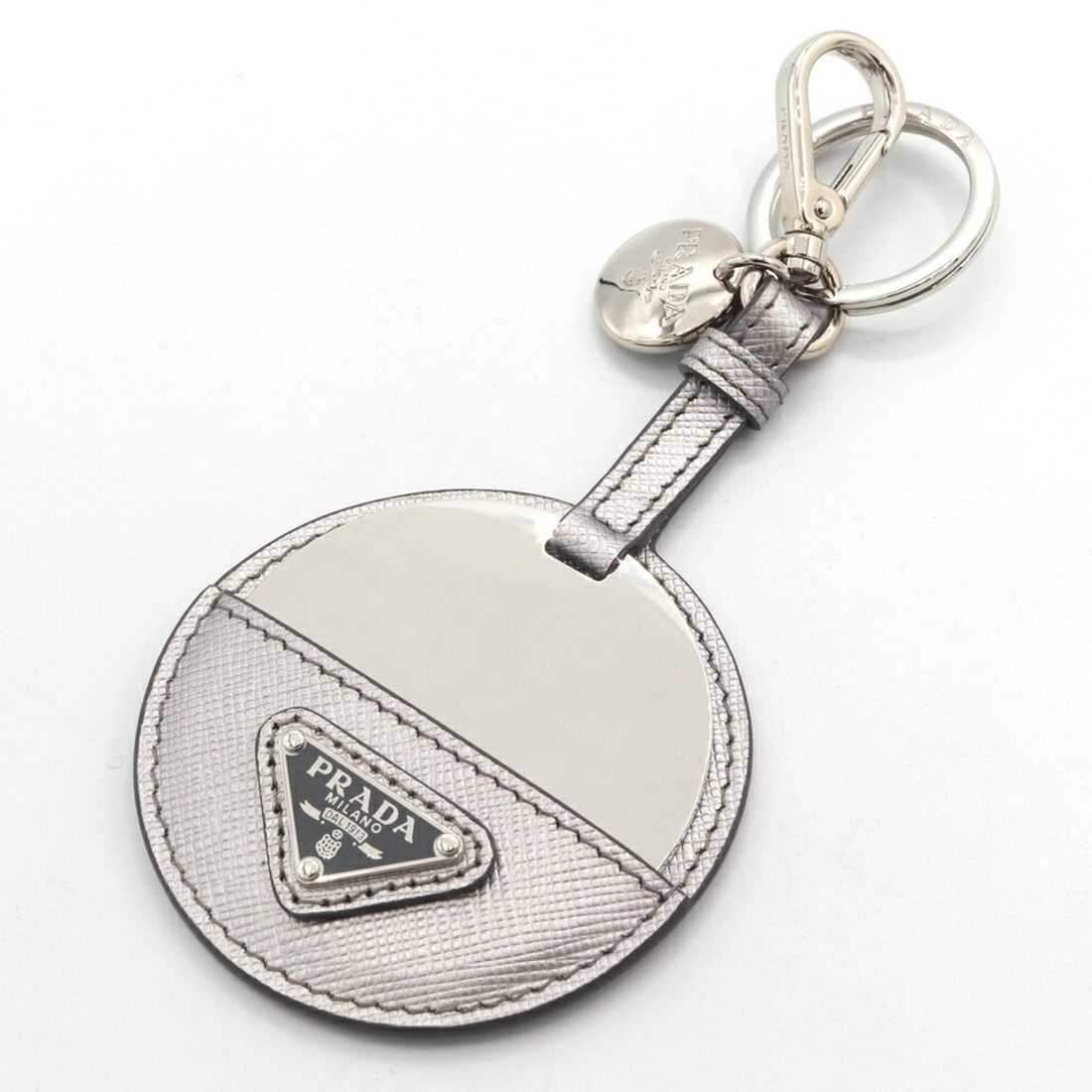 Prada Keychain 1TL489 Silver Leather Metal Mirror Charm Key Ring Accessory Bag Women's PRADA: --- Catalog ---Category: DesignType: KeyringColor: SilverGender: WomenMaterial: Leather, MetalCategory: GeneralMPN: 1TL489Brand: Prada--- Item List ---Section: ConditionRanking: Rank S Used - Mint con