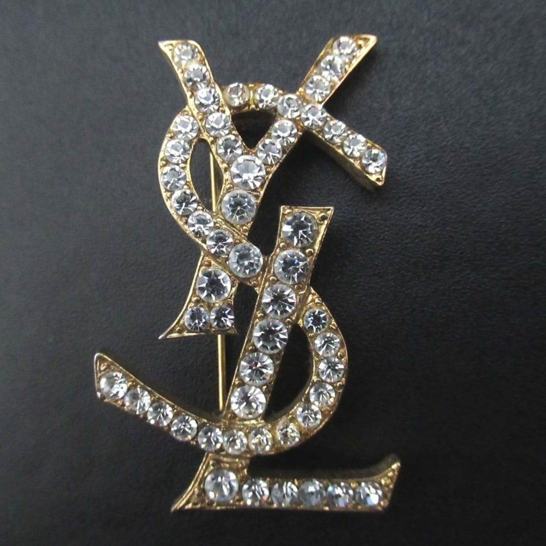 YVES SAINT LAURENT Vintage Cassandra Logo Rhinestone Brooch, Gold, Women's: --- Catalog ---Category: SizeSize (HxWxD): 5.3cm x 3.3cm / 2.08'' x 1.29''Category: DesignType: BroochColor: GoldStone: RhinestoneGender: WomenCategory: GeneralBrand: Yves Saint Laurent--- Item List -