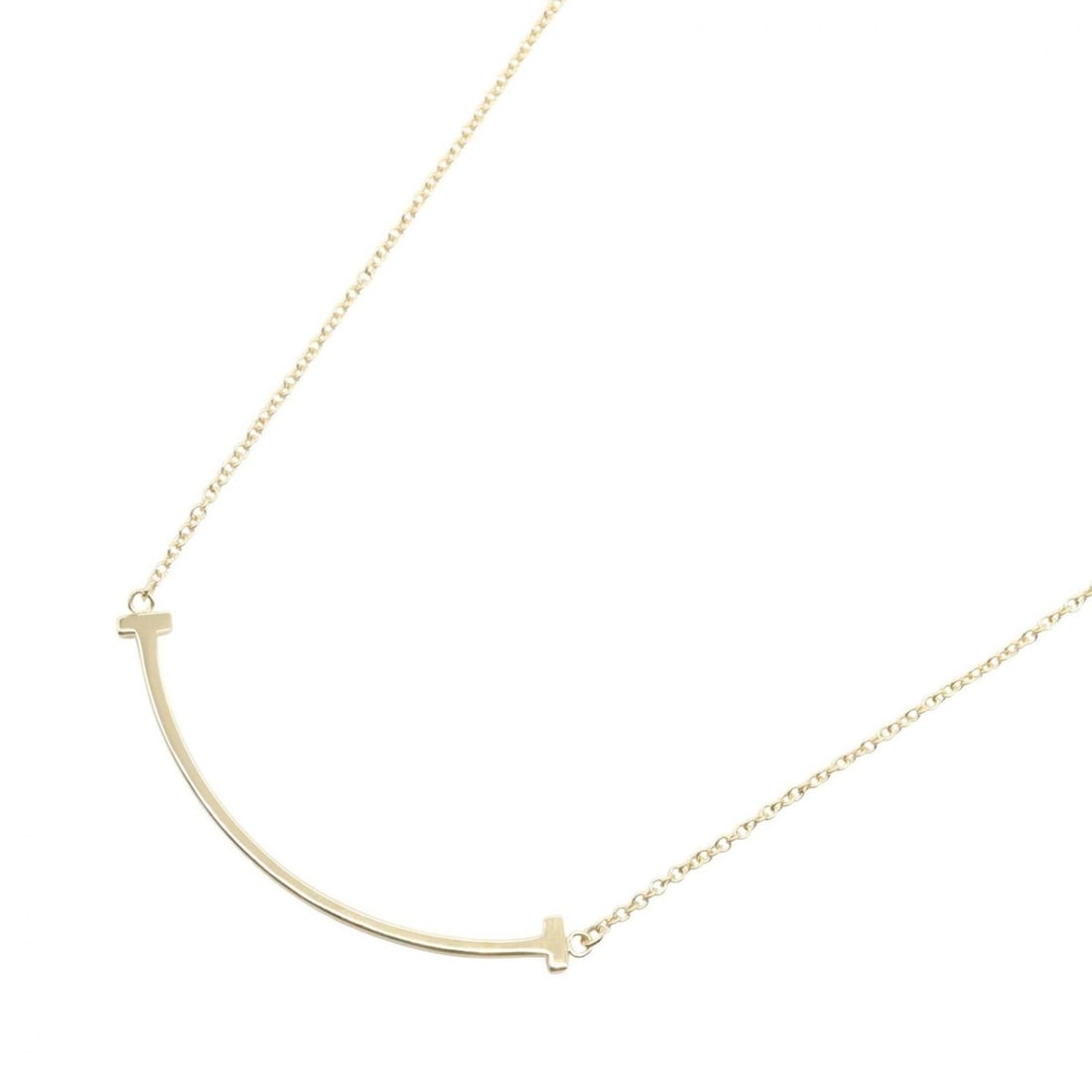 Tiffany & Co. T Smile Small Necklace, 18K Yellow Gold, Women's: --- Catalog ---Category: SizePendant Size: 3mm x 35mm / 0.11'' x 1.37''Neck Circumference: 35 cm - 37.5 cm / 13.77'' - 14.76''Category: DesignColor: Yellow goldGender: WomenMaterial: Yellow gold (18K)