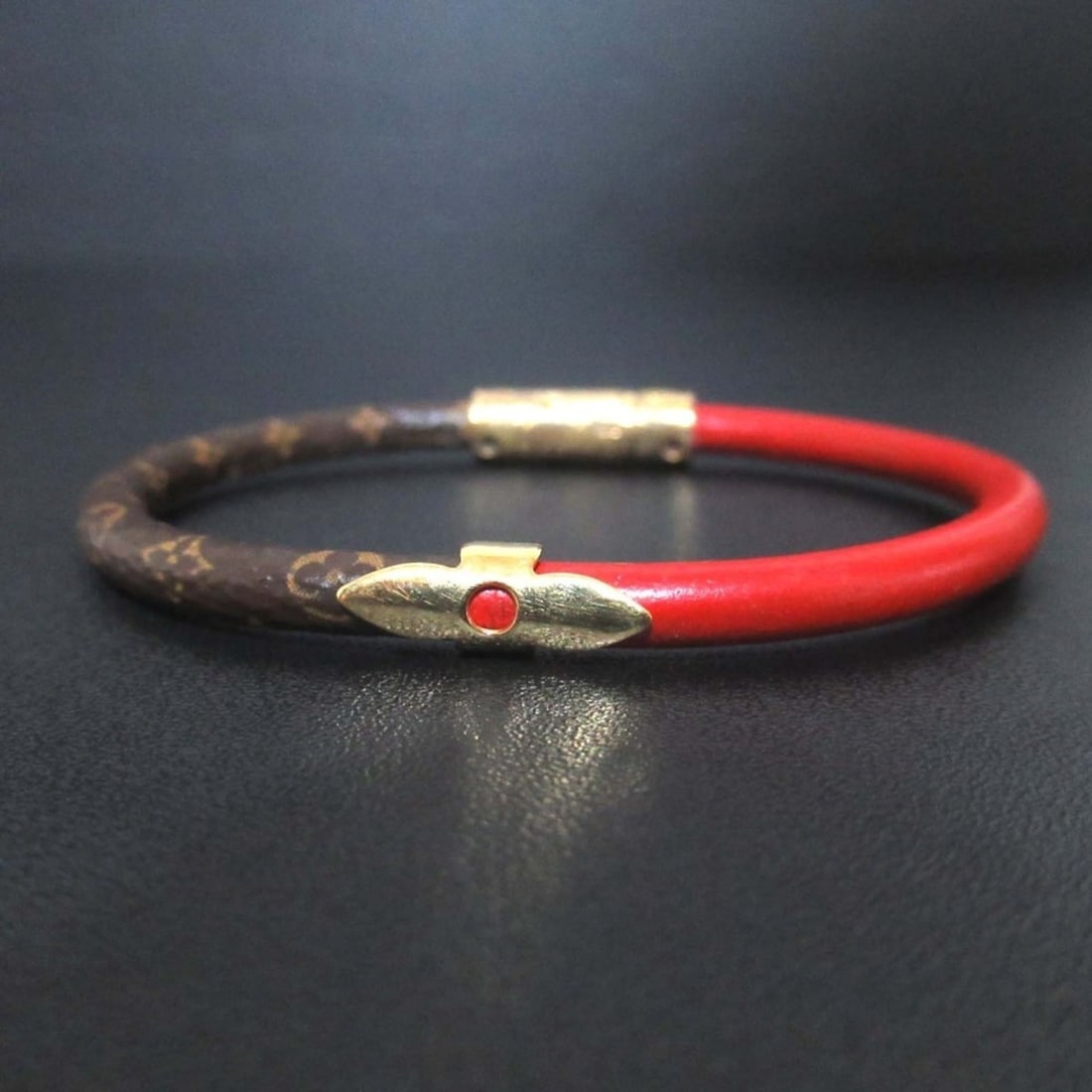 LOUIS VUITTON Louis Vuitton Brassle Daily Confidential Bracelet in Brown, Red, and Gold Hardware for: --- Catalog ---Category: SizeLength: 16.5cm / 6.49''Category: DesignType: Charm braceletColor: Brown, Gold, Red colorGender: Men,WomenCategory: GeneralBrand: Louis Vuitton--- Item List ---Section: Con