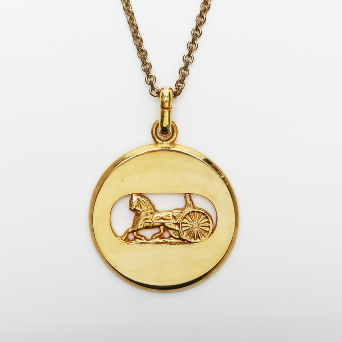 Celine Horse-Drawn Metal Necklace, Gold, WS23362: --- Catalog ---Category: SizePendant Size: 55mm x 45mm / 2.16'' x 1.77''Neck Circumference: 54 cm / 21.25''Category: DesignColor: GoldGender: WomenNecklace Type: NecklaceCategory: GeneralBrand: Celine