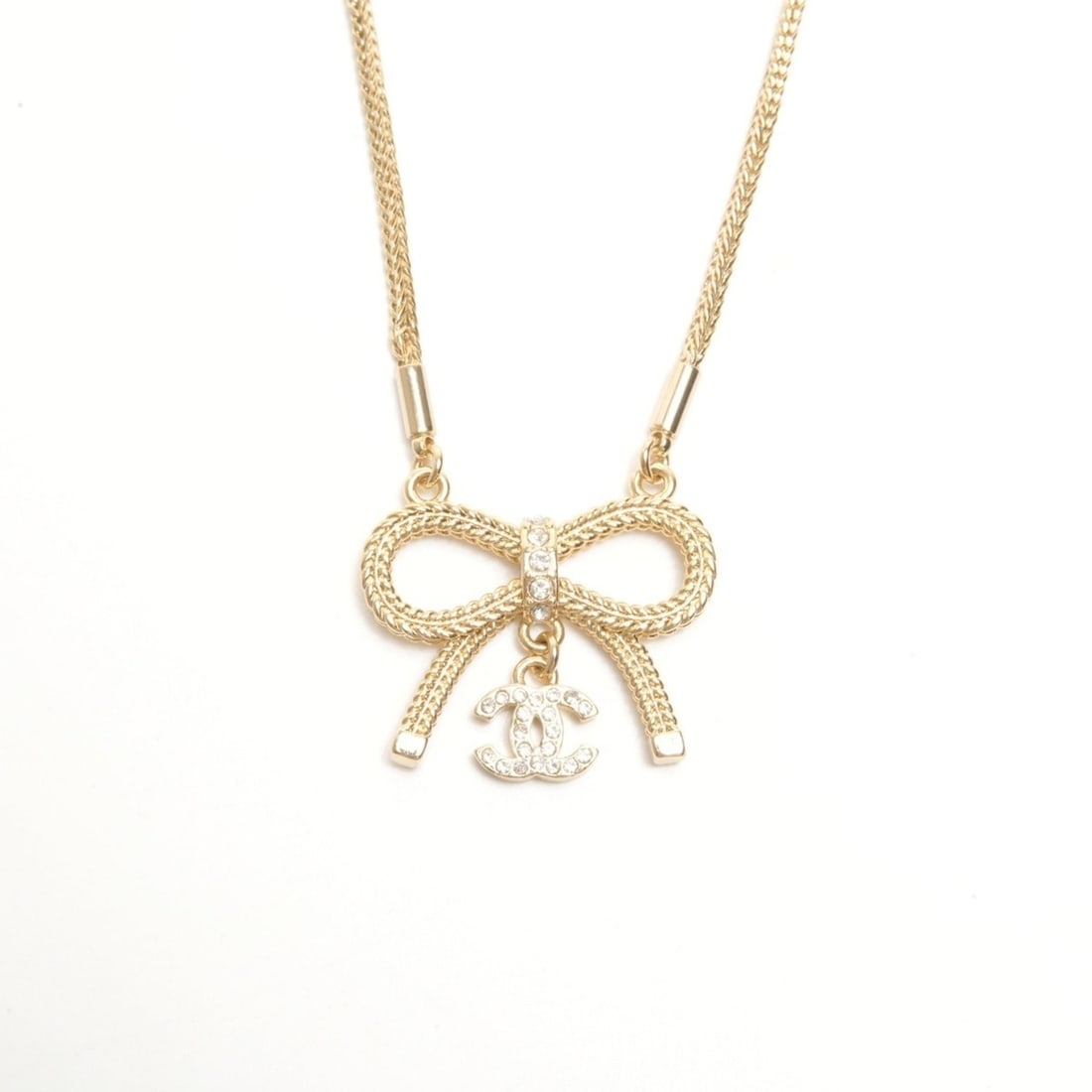 CHANEL B24C 2024 Coco Mark Ribbon Rhinestone Necklace Gold WS24423: --- Catalog ---Category: SizePendant Size: 20mm x 28mm / 0.78'' x 1.1''Neck Circumference: 52 cm / 20.47''Category: DesignColor: GoldStone: RhinestoneGender: WomenNecklace Type: NecklaceCategory: Gene