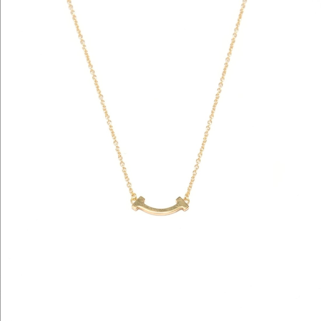 Tiffany & Co. Au750 T Smile Necklace, Gold, WS24850: --- Catalog ---Category: SizePendant Size: 12mm x 15mm / 0.47'' x 0.59''Category: DesignColor: GoldGender: WomenNecklace Type: NecklaceCategory: GeneralBrand: TiffanyCountry of Origin: USA--- Item Lis
