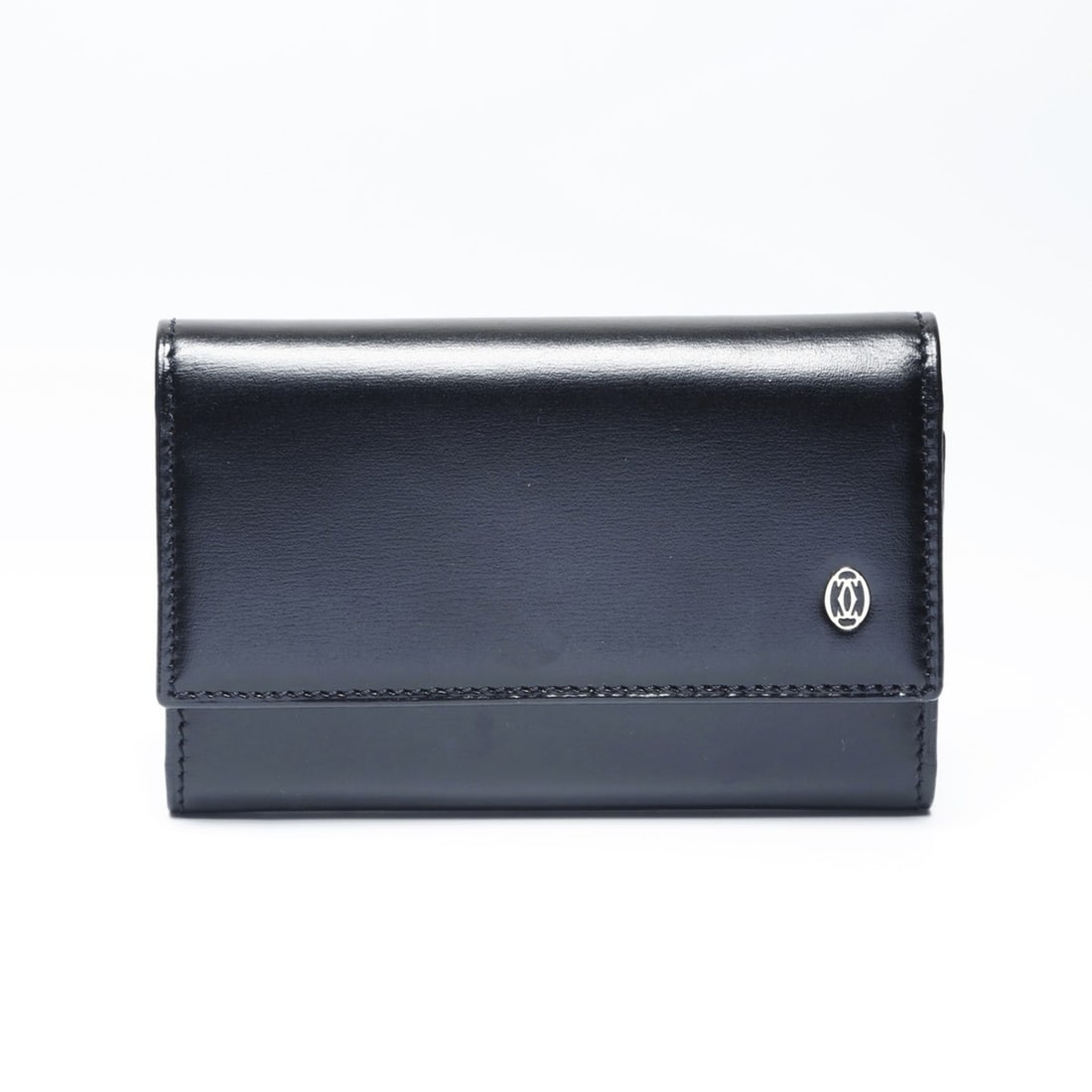 Cartier Leather Key Case in Black: --- Catalog ---Category: DesignType: KeycaseColor: BlackGender: WomenCategory: GeneralBrand: CartierCountry of Origin: FranceCategory: Physical PropertiesSize (HxWxD): 6.5cm x 10cm x 2cm / 2.55'' x