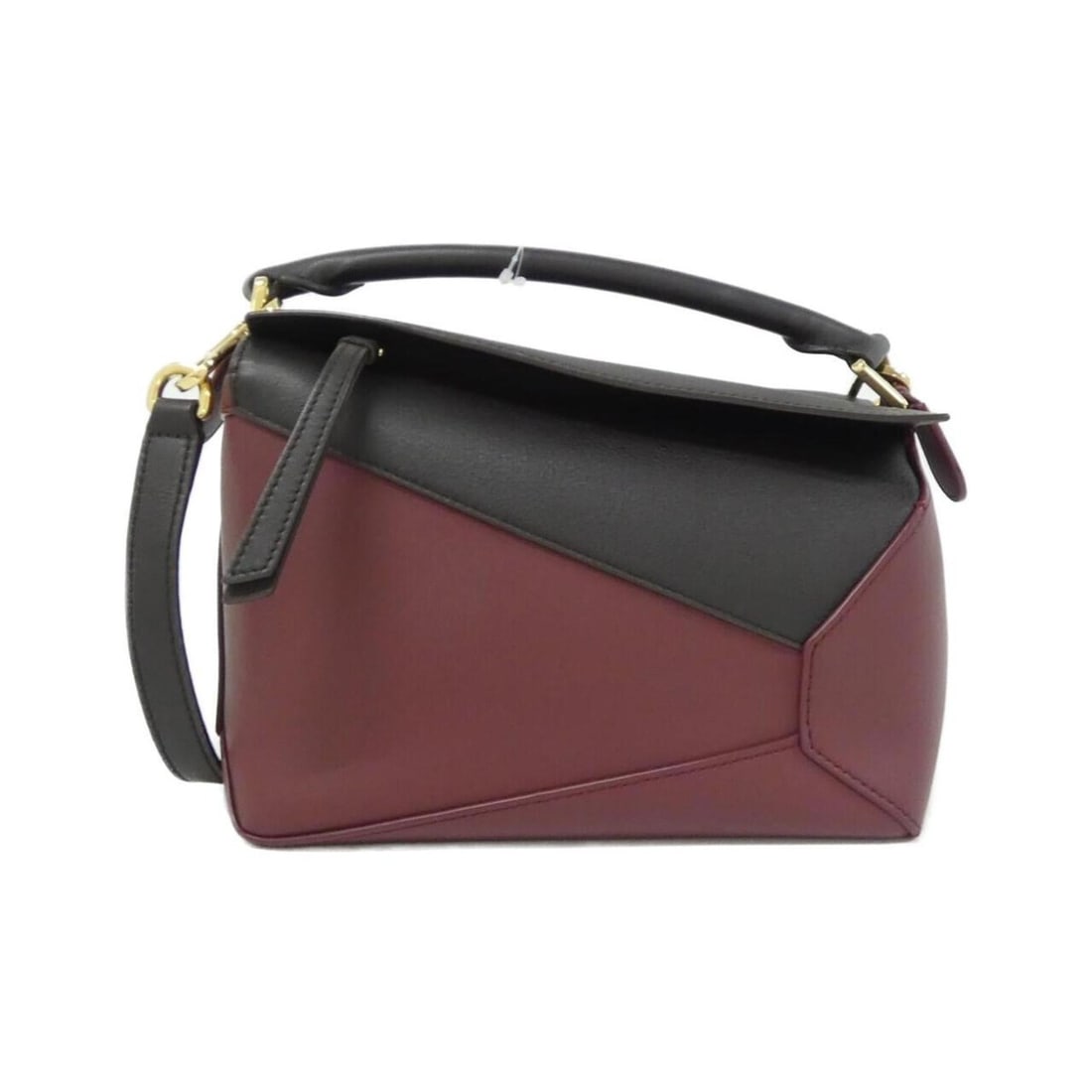 Loewe Pazzul Edge Small A510P60X44 Handbag: --- Catalog ---Category: SizeSize (HxWxD): 16cm x 24cm x 10cm / 6.29'' x 9.44'' x 3.93''Category: DesignType: HandbagColor: Burgundy, ChocolateGender: WomenMaterial: Leather Hardware Color: GoldLeathe