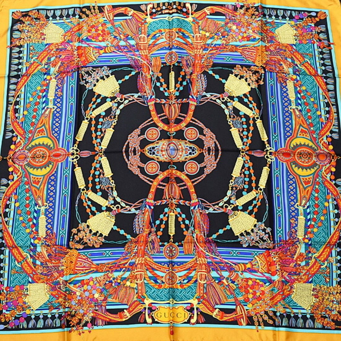 Gucci Scarf/Muffler for Women, Tassel Design, Large Shawl, 100% Silk, Black & Gold: --- Catalog ---Category: SizeSize (LxW): 88cm x 88cm / 34.64'' x 34.64''Category: DesignType: ScarfColor: BlackGender: WomenMaterial: Silk Category: GeneralBrand: GucciCountry of Origin: Italy--- Item