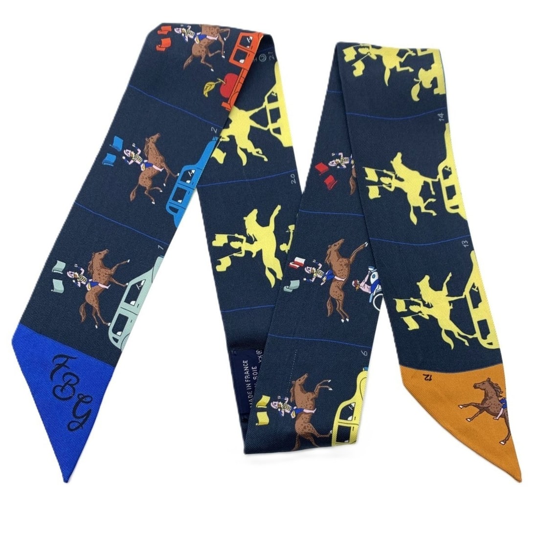 Hermes Twilly Scarf/Muffler, Parade design, Navy/Multicolor, 100% Silk.: --- Catalog ---Category: SizeSize (LxW): 86cm x 6cm / 33.85'' x 2.36''Category: DesignType: ScarfColor: Multi-color, NavyMaterial: Silk 100%Category: GeneralLine: TwillyBrand: Hermes--- Item List ---S