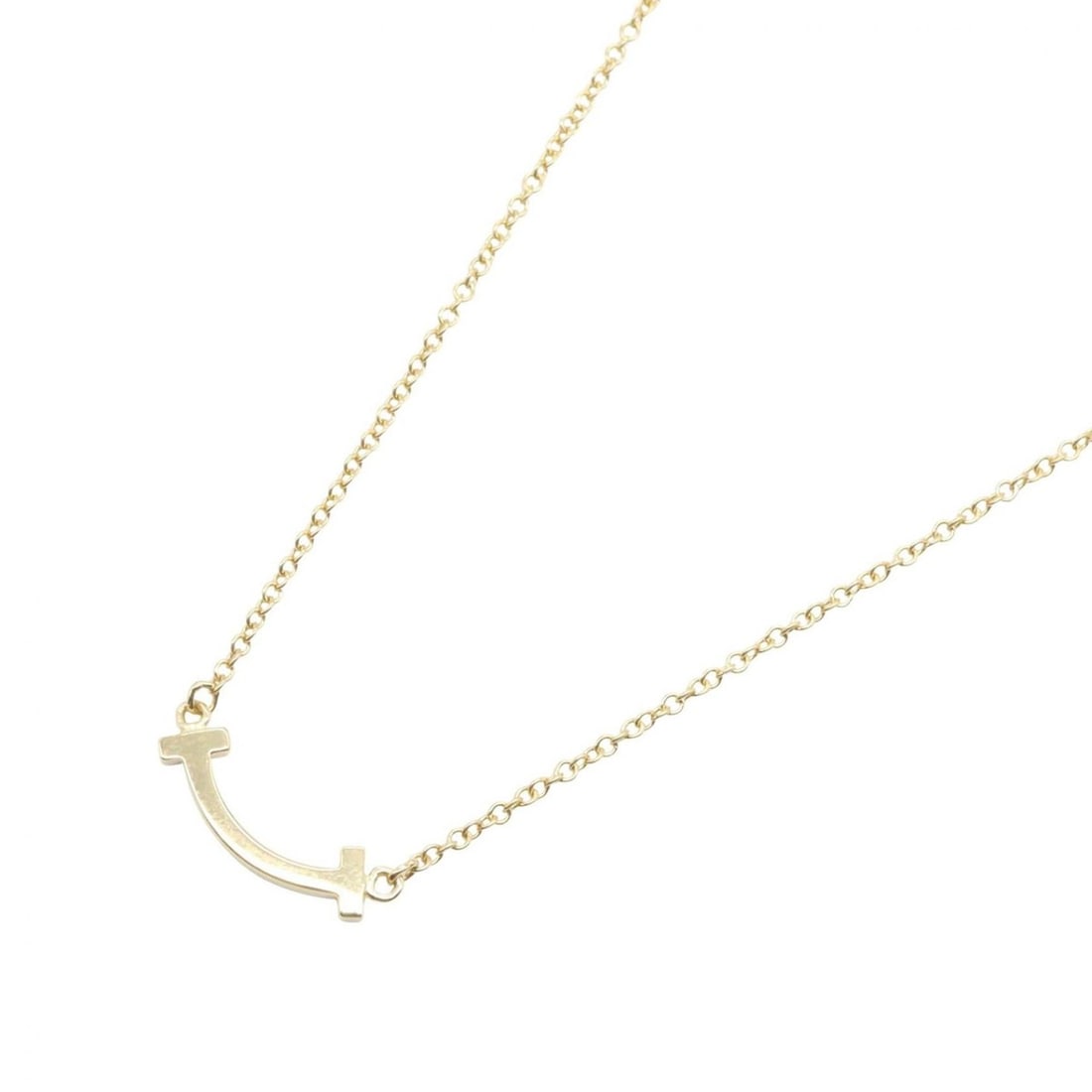 Tiffany & Co. T Smile Mini Necklace, 18K (Yellow Gold), Women's Jewelry, Gold Tone: --- Catalog ---Category: SizePendant Size: 3mm x 13mm / 0.11'' x 0.51''Neck Circumference: 40.5 cm - 46 cm / 15.94'' - 18.11''Category: DesignColor: GoldGender: WomenMaterial: Yellow gold
