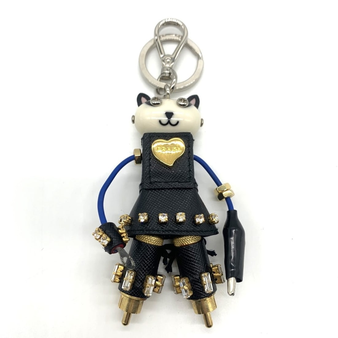 Prada Robot Cat Charm Keychain White x Black Triangle 1TR018 PRADA: --- Catalog ---Category: SizeWeight: 62g / 2.18oz.Size (HxWxD): 14.5cm x 6cm / 5.7'' x 2.36''Category: DesignType: KeyringColor: Black, WhiteGender: WomenMaterial: Leather, Stainless steelCategory: Ge
