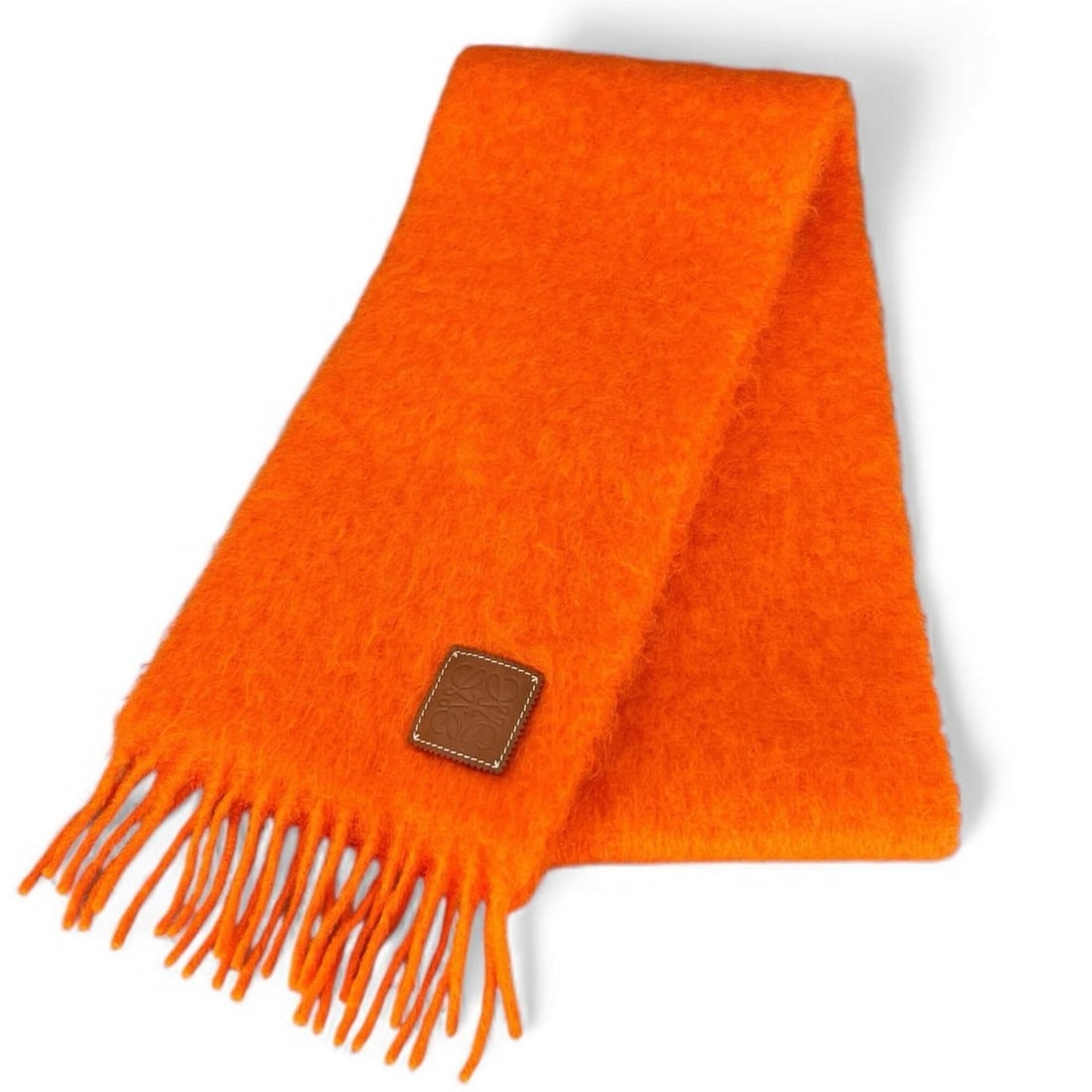 LOEWE Mohair Wool Anagram Leather Patch Fringe Scarf, Orange, Made in Spain, Authentic, Women's: --- Catalog ---Category: SizeSize (LxW): 2.04m x 21.5cm / 80.31'' x 8.46''Category: DesignType: StoleColor: OrangeGender: WomenMaterial: Mohair , Wool , Nylon Category: GeneralBrand: LoeweCountry of