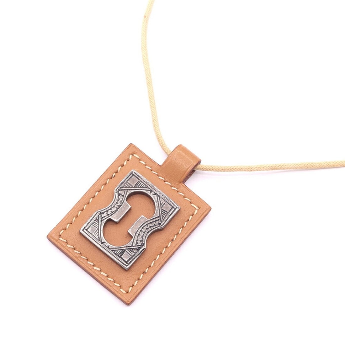 Hermes Touareg Necklace, Brown Leather and Cotton, ?F Stamp, Manufactured in 2002, Choker,: --- Catalog ---Category: SizeWidth: 2mm / 0.08''Weight: 12.5g / 0.44oz.Pendant Size: 48.3mm x 32.2mm / 1.9'' x 1.26''Neck Circumference: 44.5 cm / 17.51''Category: DesignColor: BrownGender: WomenMater