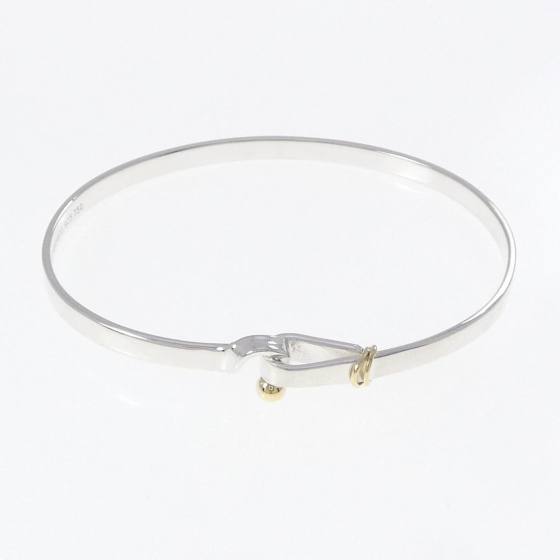 Tiffany Hook & Eye Bangle: --- Catalog ---Category: SizeLength: 18cm / 7.08''Category: DesignType: BangleColor: Silver, Yellow goldGender: WomenMaterial: Silver 925, Yellow gold (18K)Category: GeneralBrand: Tiffany--- Item List