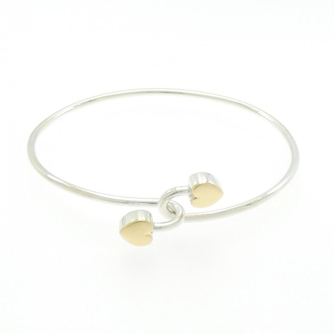 Tiffany Solid Double Heart Bangle: --- Catalog ---Category: SizeLength: 17.5cm / 6.88''Category: DesignType: BangleColor: Silver, Yellow goldGender: WomenMaterial: Silver 925, Yellow goldCategory: GeneralBrand: Tiffany--- Item List ---