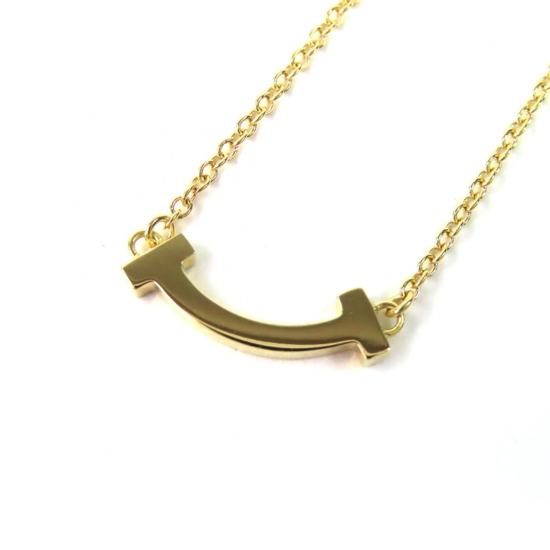 TIFFANY&Co. Tiffany T Smile Mini Pendant Necklace, 45.6cm, Current Model, Yellow Gold, Comes with: --- Catalog ---Category: SizeWeight: 2.35g / 0.08oz.Pendant Size: 3mm / 0.11''Neck Circumference: 40.5 cm - 45 cm / 15.94'' - 17.71''Category: DesignColor: Yellow goldGender: WomenMaterial: Yellow gol