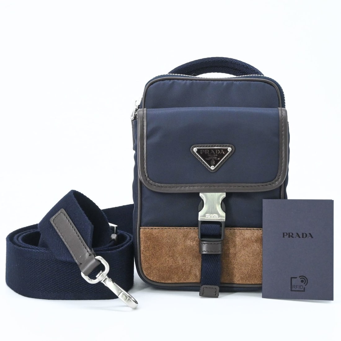PRADA Suede and Nylon Shoulder Bag, Triangle Design, Navy Brown: --- Catalog ---Category: SizeSize (HxWxD): 17cm x 12cm x 4cm / 6.69'' x 4.72'' x 1.57''Category: DesignType: Shoulder bagColor: Brown, NavyGender: WomenMaterial: Suede , Nylon Category: GeneralBrand: 