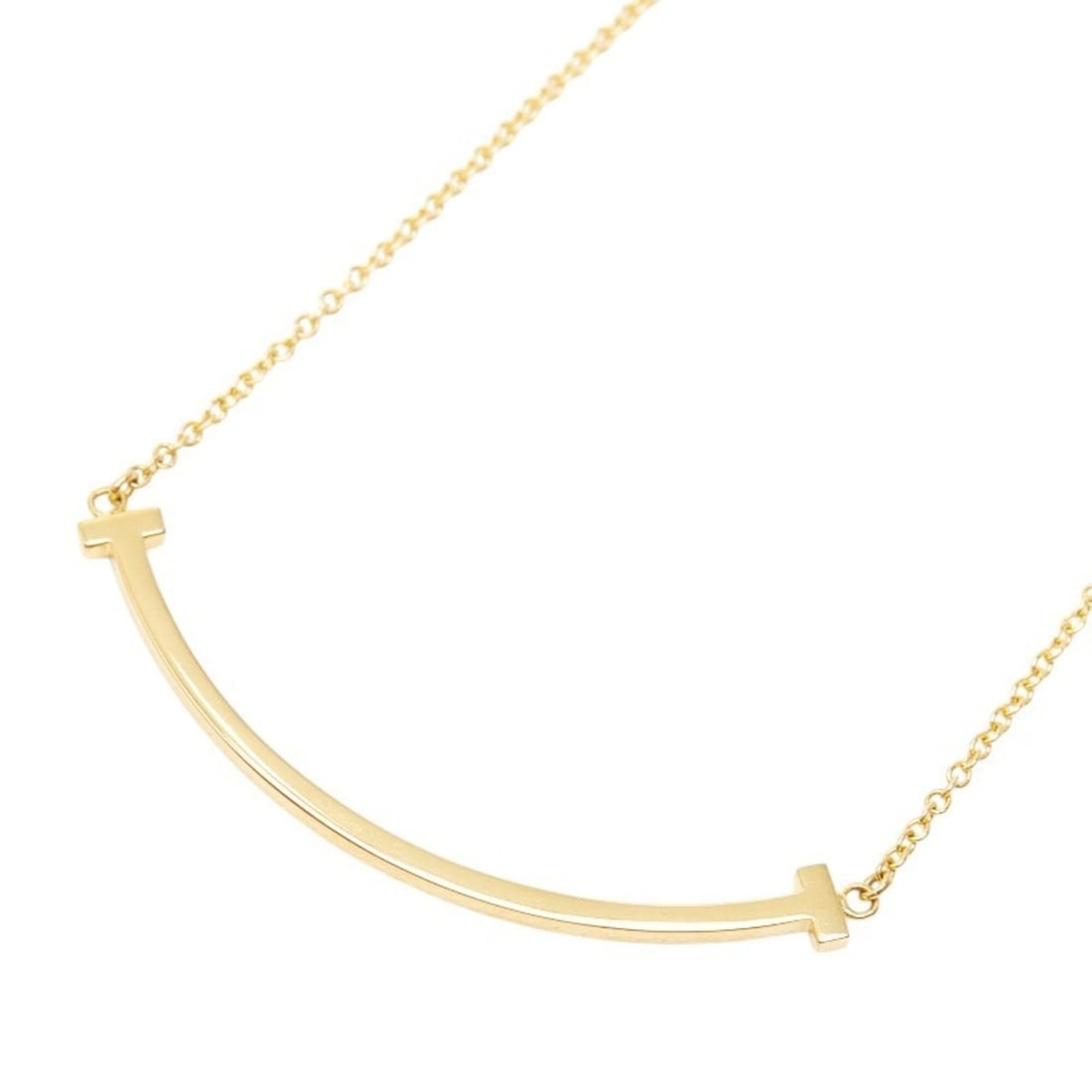 Tiffany & Co. 60011679 Gold 18KYG Yellow T Smile Pendant Small Necklace for Women: --- Catalog ---Category: SizePendant Size: 9mm x 37mm / 0.35'' x 1.45''Neck Circumference: 46.7 cm / 18.38''Category: DesignColor: Yellow goldGender: WomenMaterial: Yellow gold (18K)Pendant Type: Pend