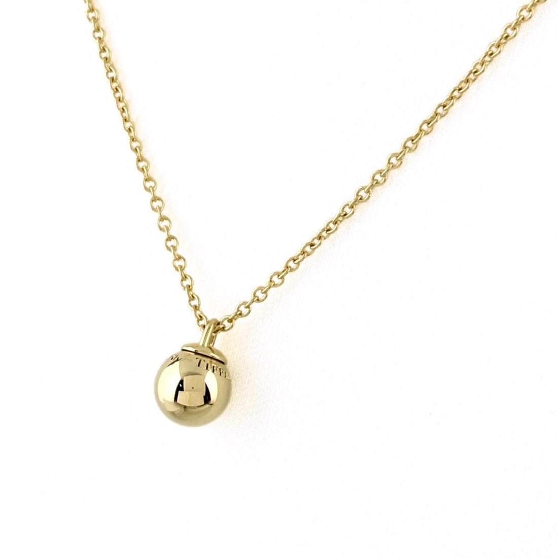 Tiffany & Co. Ball Necklace, Yellow Gold (YG) Pendant, Sphere 750 Gold, Women's.: --- Catalog ---Category: SizeWidth: 1.2mm / 0.05''Weight: 4.9g / 0.17oz.Pendant Size: 10.9mm x 7.5mm / 0.42'' x 0.29''Neck Circumference: 45.5 cm / 17.91''Category: DesignColor: Yellow goldGender: Wom