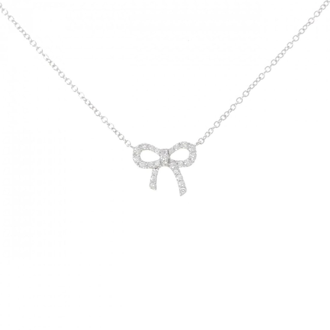 Tiffany Metro Bow Mini Necklace: --- Catalog ---Category: SizePendant Size: 9.2mm x 10.7mm / 0.36'' x 0.42''Neck Circumference: 41 cm / 16.14''Category: DesignStone: DiamondGender: WomenMaterial: White gold (18K)Pendant Type:
