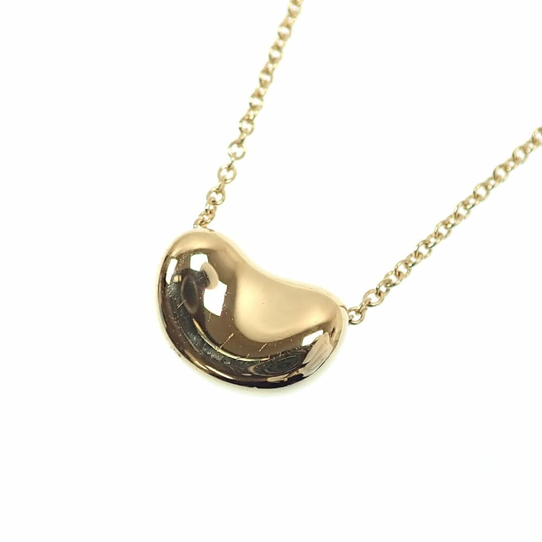 Tiffany & Co. Bean Necklace for Women, 18K Yellow Gold, 2.9g, 750 (18k Gold), Design, by Elsa: --- Catalog ---Category: SizeWeight: 2.9g / 0.1oz.Pendant Size: 7mm x 10mm / 0.27'' x 0.39''Neck Circumference: 41 cm / 16.14''Category: DesignGender: WomenMaterial: Yellow gold (18K)Necklace Type: Ne