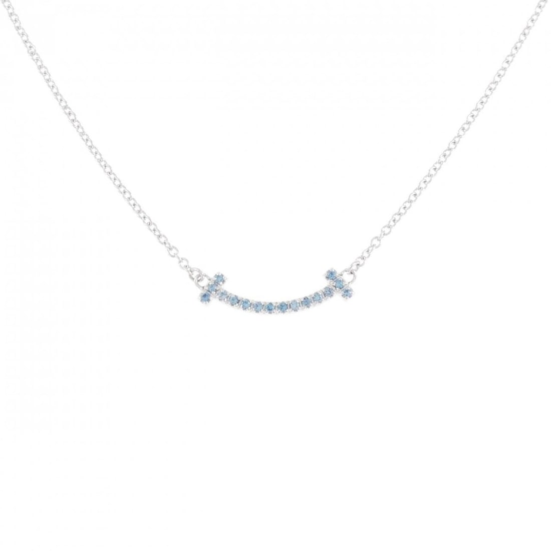 Tiffany & Co. T Smile Micro Holiday Limited Edition Necklace: --- Catalog ---Category: SizePendant Size: 3.6mm x 15.4mm / 0.14'' x 0.6''Neck Circumference: 40 cm - 45 cm / 15.74'' - 17.71''Category: DesignColor: White goldStone: TopazGender: WomenMaterial: