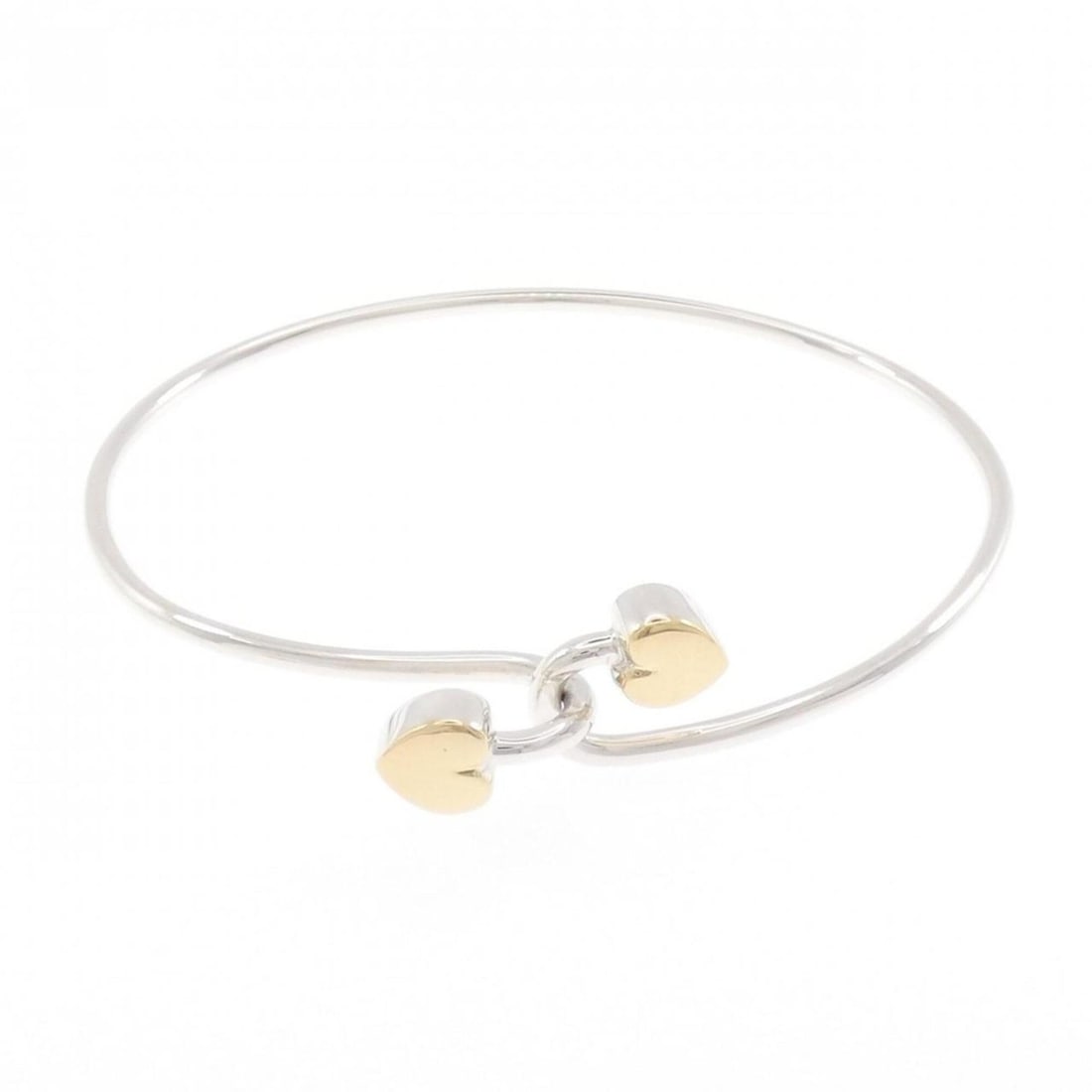 Tiffany Solid Double Heart Bangle: --- Catalog ---Category: SizeLength: 17cm / 6.69''Category: DesignType: BangleColor: Silver, Yellow goldGender: WomenMaterial: Silver 925, Yellow gold (18K)Category: GeneralBrand: Tiffany--- Item