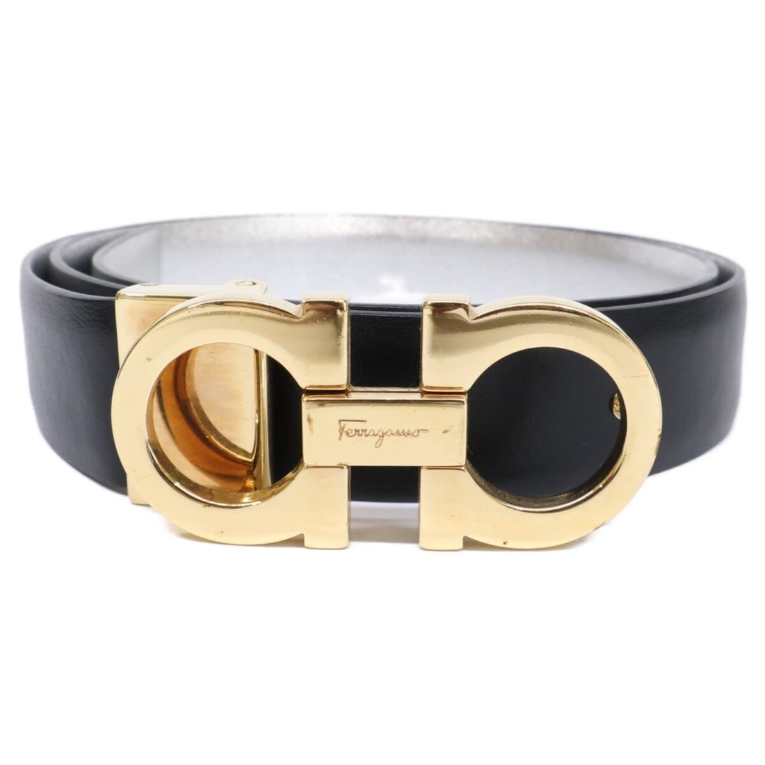 Salvatore Ferragamo Gancini buckle reversible leather belt, black, metallic silver, and gold color,: --- Catalog ---Category: SizeLength: 72cm - 78cm / 28.34'' - 30.7''Category: DesignType: Standard beltColor: Black, Gold, SilverGender: WomenMaterial (Strap): Leather Category: GeneralBrand: Salvatore