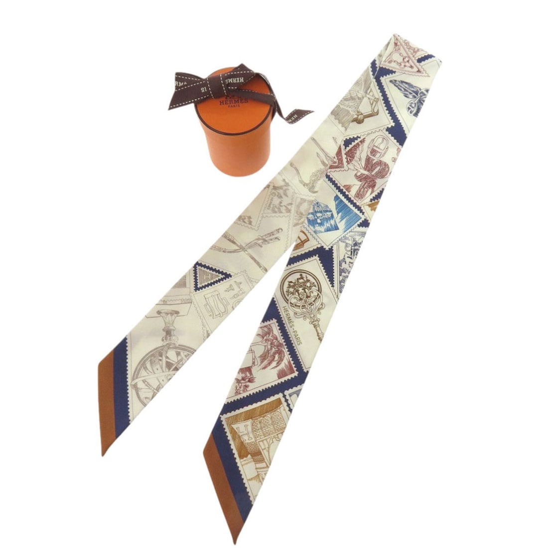 Like new Hermes Twilly Faubourg Stamp Enthusiast Silk Blue Marine Crème Caramel Scarf Muffler: --- Catalog ---Category: SizeSize (LxW): 86cm / 33.85''Category: DesignType: ScarfColor: Blue, Camel, CreamGender: WomenMaterial: Silk Category: GeneralBrand: HermesCountry of Origin: France--- Item L