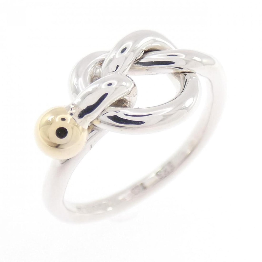 Tiffany Love Knot Ring: --- Catalog ---Category: SizeJP Size: 10.5US Size: 5.5Category: DesignType: Band ringGender: WomenMaterial: Silver 925, Yellow gold (18K)Category: GeneralBrand: Tiffany--- Item List ---Section: Condit