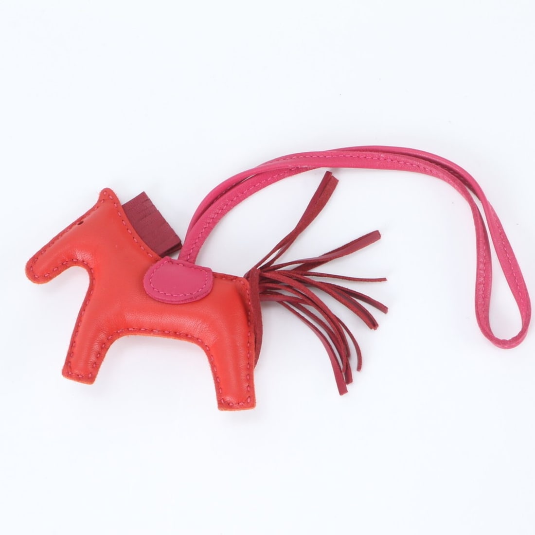 Unused Hermes Y-stamped Rodeo Charm PM in Agneau Milo leather, accessory bag charm/strap for women.: --- Catalog ---Category: SizeSize (HxWxD): 8.00mm x 9.00mm / 0.31'' x 0.35''Category: DesignType: Handbag charmColor: Pink, Red colorGender: WomenMaterial: LeatherCategory: GeneralBrand: HermesCountry