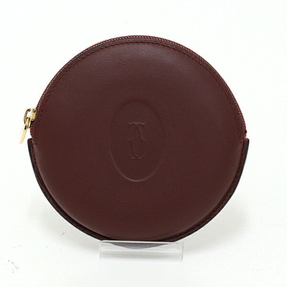 Cartier Must Line Coin Case, Bordeaux Calfskin: --- Catalog ---Category: SizeSize (HxWxD): 9.5cm x 10cm x 2cm / 3.74'' x 3.93'' x 0.78''Category: DesignType: Coin purse/coin caseColor: BordeauxGender: Women,MenMaterial: Leather Category: