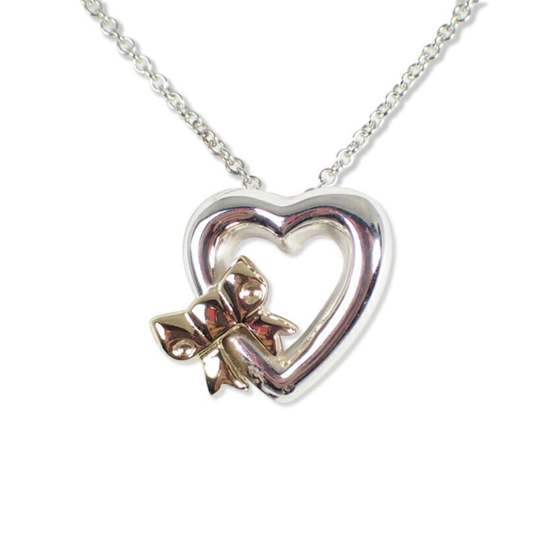 TIFFANY & Co. 925 750 Heart Ribbon Pendant Necklace: --- Catalog ---Category: SizePendant Size: 13mm x 12.5mm / 0.51'' x 0.49''Neck Circumference: 41 cm / 16.14''Category: DesignColor: Silver, Yellow goldGender: WomenMaterial: Sterling silver 925, Yello
