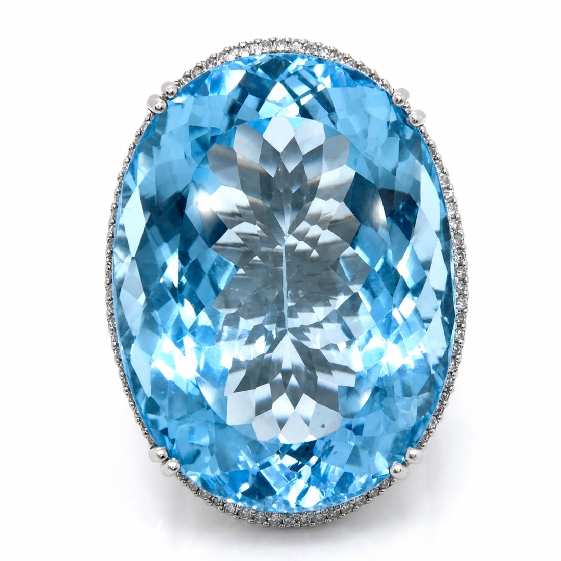 14K WG 140.00 Ct. Blue Topaz Ring: 14K White Gold. Statement ring featuring a massive 140.00 Ct. Blue Topaz. Diamond side accents.
