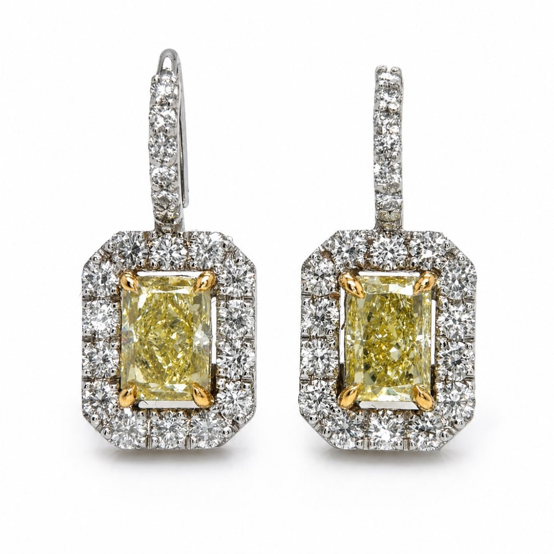 GIA Certified Fancy Yellow Earrings: GIA Certified; Natural Fancy Yellow Radiant cut centers; Double halo diamond design in 18K Two-Tone gold.