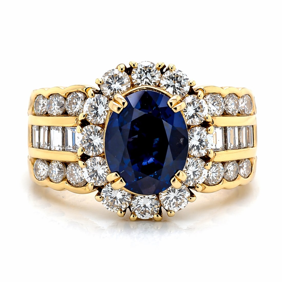 18K YG 1.89 Ct. Sapphire & Diamond Ring: 18K Yellow Gold; 1.89 Ct. Blue Sapphire center; Traditional diamond cluster halo.
