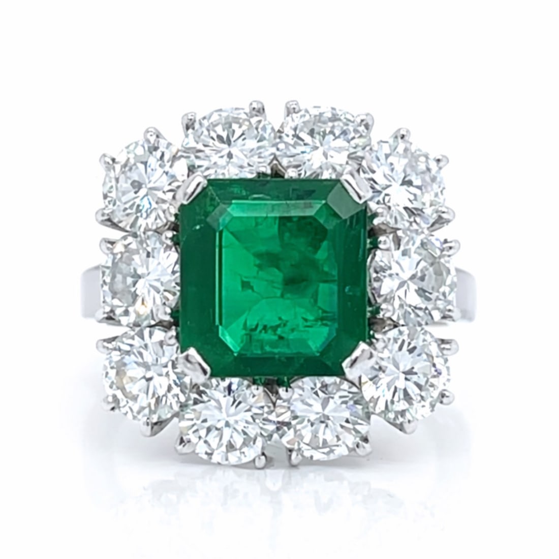 Platinum Emerald & Diamond Ring: Solid Platinum; Natural Emerald center stone flanked by high-clarity diamonds.