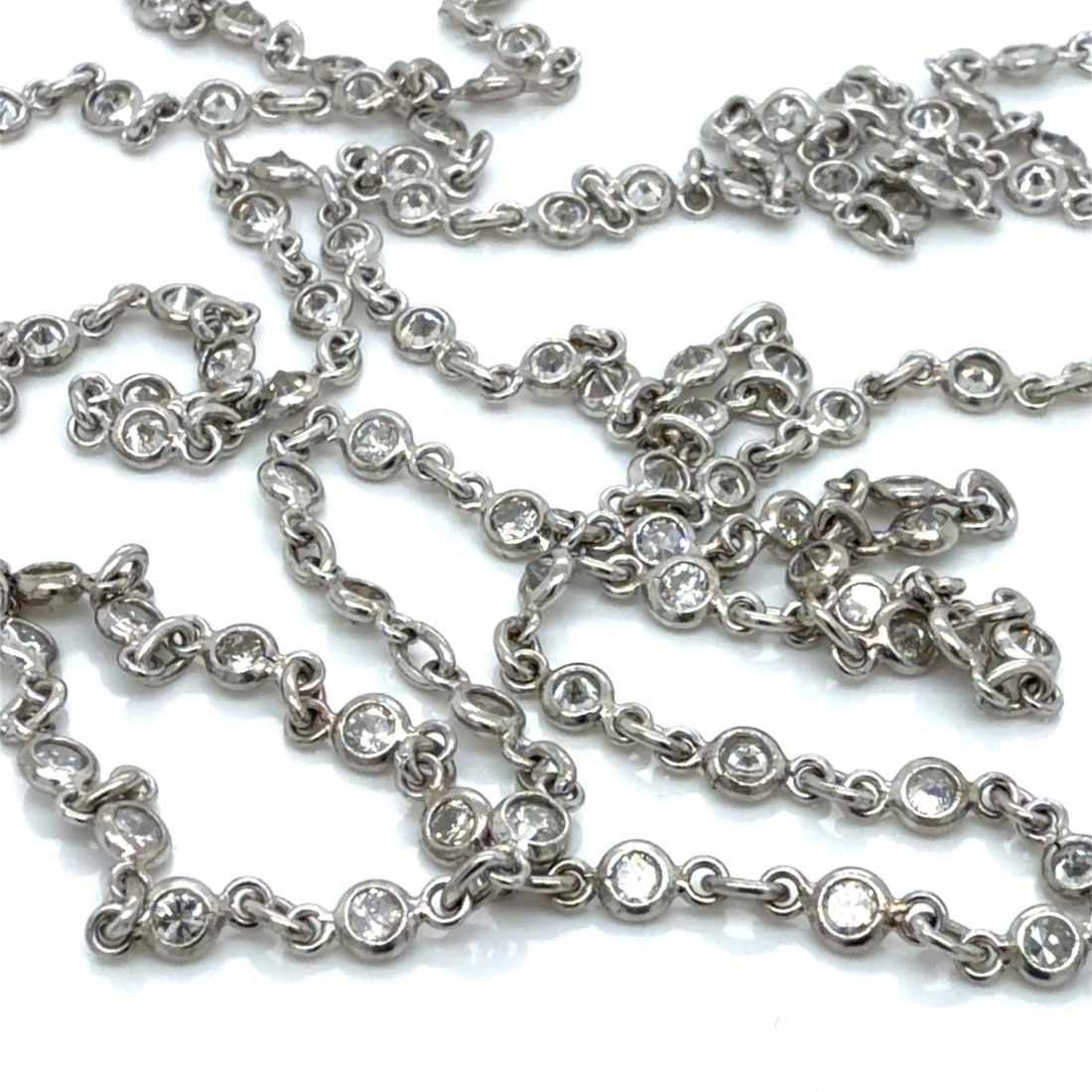 Platinum 5.00 Ct. Diamond by the Yard Necklace: Solid Platinum station chain; 5.00 Ct. total weight of bezel-set round brilliant diamonds; Classic length.