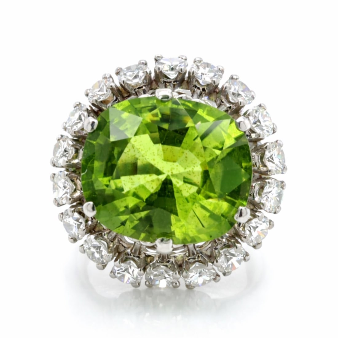 1960’s Platinum Peridot & Diamond Ring: 1960s Mid-Century Vintage; Platinum mounting; Fine vibrant Peridot center stone with diamond details.