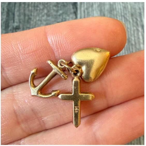 Vintage Faith, Hope and Love Charms in 14K Gold: Classic allegorical charm grouping. Comprises a matching trio of solid 14K tokens attached to a single jump ring: a Latin Cross (Faith), a traditional maritime anchor (Hope), and a puffed polished hea