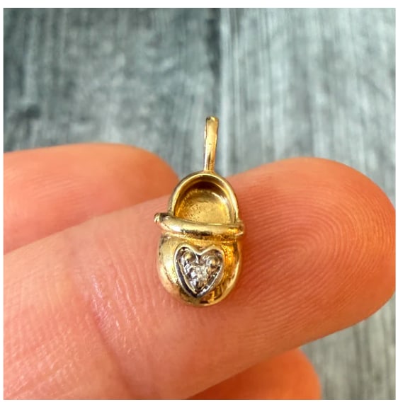 Mini Diamond Baby Shoe Charm in 14K Gold: Precious, highly detailed 3D miniature baby bootie shoe token in 14K yellow gold. Features a realistic creased toe cap entirely micro pave-set with tiny single-cut white accent diamonds (approx. 0.05 
