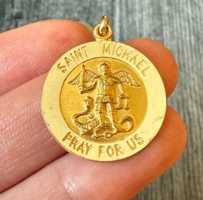 14K Gold Saint Michael Medal Charm: Substantial protection amulet beautifully showing Archangel Michael slaying the dragon in frosted bas-relief detail, encompassed by a heavy, thick diamond-cut frame border. Diameter: 21 mm. Weight: 4.